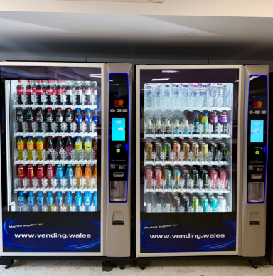Two vending machines filled with various canned beverages.