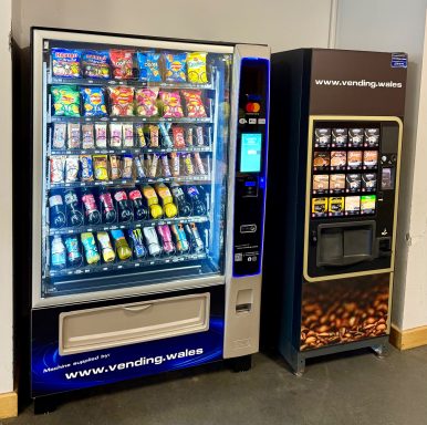 vending machines displaying a variety of snacks, drinks and hot beverages.